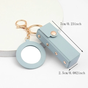 Detail of light blue PU leather lipstick holder keychain with mirror and gold hardware