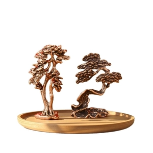 Vintage brass pine tree figurines set on wooden tray for zen office desk decor