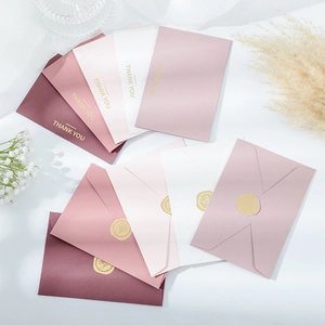 Detail of Thank You greeting cards with gold foil text and wax seal stickers on envelopes