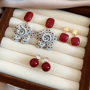 Detailed set of three red vintage earrings including floral, square and bead designs