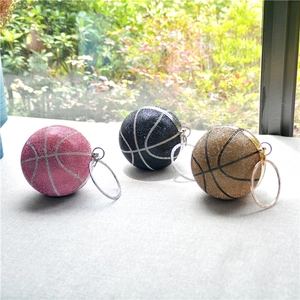 Three rhinestone basketball handbags in pink, black, and gold with metal handles