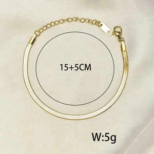 Detail of a vintage golden flat snake chain bracelet with adjustable lobster clasp closure
