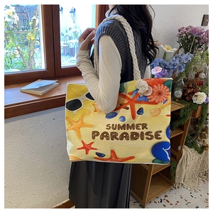 Close-up of summer paradise canvas tote bag featuring starfish shell and rope handle