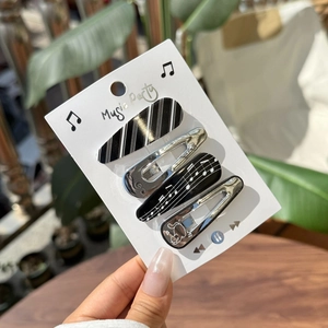 Music-themed hair clip set with piano notes and cat patterns in black and silver