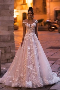 Detail of off-shoulder wedding dress featuring 3D floral embroidery and lace appliqué