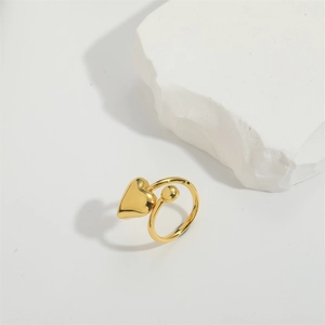 Detailed top view of 14K gold-plated heart and bead open ring on white stone base