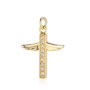 Detailed close-up of a gold cross pendant with wing design and sparkling crystal inlay
