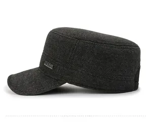 Detail view of dark grey winter cadet cap with thick wool texture and metal side badge