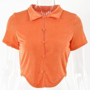 Detailed view of orange cropped cardigan with lapel collar and single-breasted button design