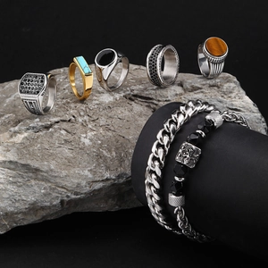 Men's hip hop jewelry set with turquoise rings and bracelets on natural grey rocks