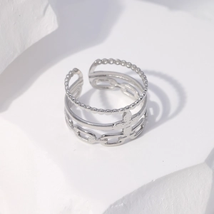 Detail of silver multi-layer stainless steel ring with clover motif on stone display