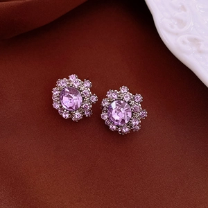 Macro shot of purple crystal flower earrings with silver plating and radiant facets