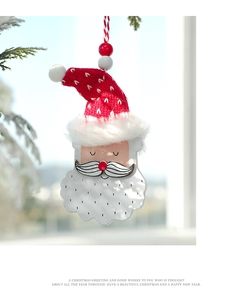 Detail of wooden Santa Claus ornament with red knit hat and festive beads decoration