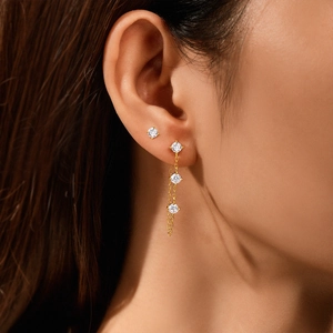 Macro shot of s925 silver gold-plated stud earring set with sparkling zircon crystals