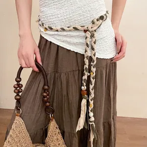 Bohemian hand-woven linen waist belt with resin beads and tassels on a model