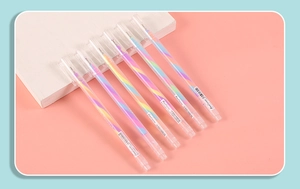 Detailed close-up of six rainbow spiral gel pens with transparent caps on pink surface