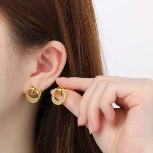 Elegant gold double interlocking twisted ring earrings with polished sphere stud detail