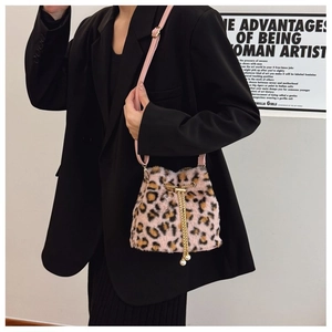 Detail of pink leopard plush bucket bag with golden chain drawstring and pearl charm