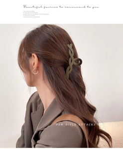 Detail of olive green matte twist hair claw clip styled on a model in a side view
