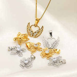 Gold and silver butterfly flower pendants with zircons on white satin background