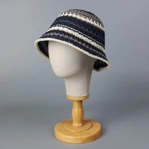 Striped knit bucket hat with blue, white, and brown crochet texture for summer