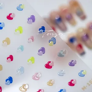 Macro detail of 3D heart nail art stickers in colorful macaron shades and 3D relief texture