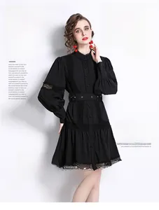 Close-up of elegant black dress featuring geometric lace lantern sleeves and belt detail