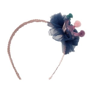 Cute girls headband with sequin crown, navy mesh flower and colorful pom-poms on white background
