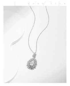 Macro shot of silver teardrop pendant necklace with pear-cut cubic zirconia and micro diamonds