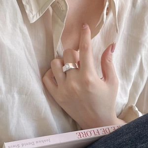 Detailed view of a silver wide band ring featuring a large rectangular cut clear stone
