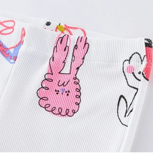 Girls ribbed knit flare pants featuring pink rabbit and floral patterns on white fabric