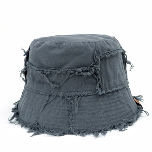 Detailed view of dark grey bucket hat with frayed edges and brown leather patch accent