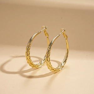 Elegant gold twisted geometric hoop earrings with a textured woven design for women
