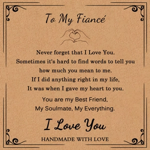 Close-up of gift card for fiancé with emotional English poem and handmade love logo