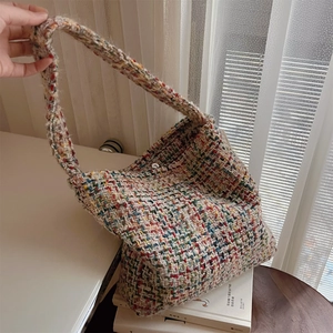 Detailed macro view of colorful chunky knit weave on a bohemian shoulder bag with strap