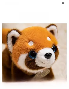 Close-up of red panda plush toy with sparkly blue eyes and soft faux fur texture