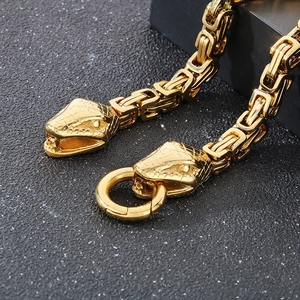 Macro view of gold Byzantine chain with snake head terminals and round spring clasp