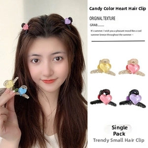 Detail shot of heart-shaped candy color hair clips in various matte pastel finishes