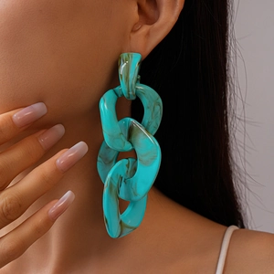 Close-up of model wearing turquoise marble acrylic chunky chain link earrings