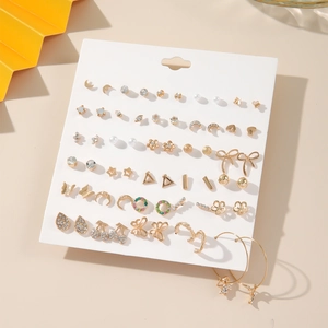 Detail view of 20-pair gold and silver heart pearl stud earring set on display card