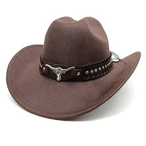 Detail of brown cowboy hat featuring silver bull head buckle and metallic studs decoration