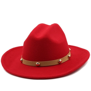 Classic red wool felt fedora with a brown studded band in a vintage western jazz style