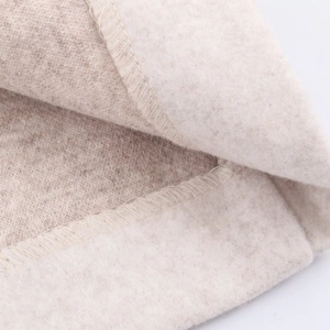 Detailed macro shot of soft cream fleece fabric with high-density fibers and clean stitching