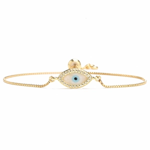 Detail of adjustable 18K gold evil eye bracelet with white zircons and sliding buckle