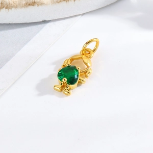 Detailed view of a gold girl pendant with a green heart-shaped gemstone for DIY jewelry