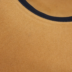 Close-up of premium wool felt fedora with a smooth camel texture and black grosgrain ribbon