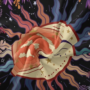 Macro shot of bohemian tapestry fabric with sun, moon and star patterns and soft folds