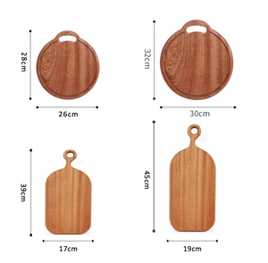 Detail view of solid ebony cutting boards in round and paddle shapes with size markings