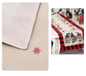 Close-up of stitching detail and festive Christmas gnome linen table runner on white table