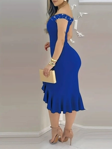 Detail of royal blue off-shoulder dress featuring pearl embellishments and ruffled hemline